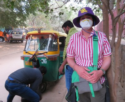 Wearing a face mask in Delhi while waiting for a tyre to be changed
