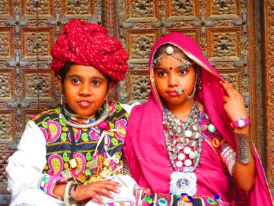 A young girl and young boy in traditional Indian dress.