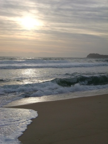 breaking waves and rising sun at Tuncurry Beach