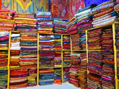 Shelves full of colourful textiles