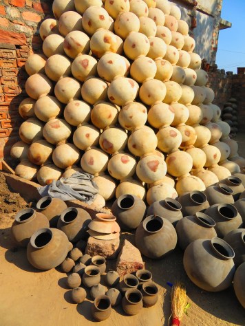 A tall stack of pottery water urns