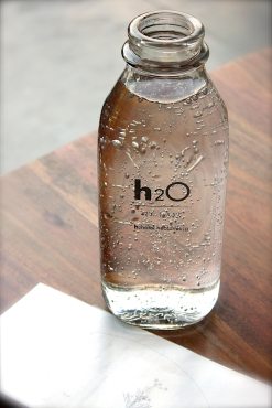 A glass bottle of water - H2O