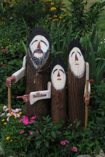 three wooden pilgrim sculptures