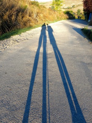 The shadows or silhouettes of two people walking the camino Frances