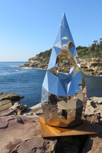 A shiny pointed sculpture with the sea in the background, Sculpture by the Sea