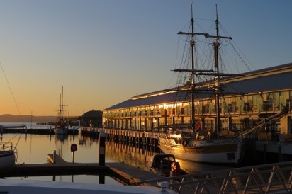 Sunrise over Constitution Dock Hobart with an old sailing boat moored at Constitution Dock
