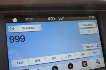 Car dashboard showing a very hot temperature at 0937