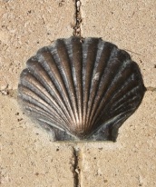 A brass shell inlaid in the footpath on the Camino Frances