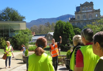 Tour guide at Cascade Brewery with Mt Wellington behind, Hobart