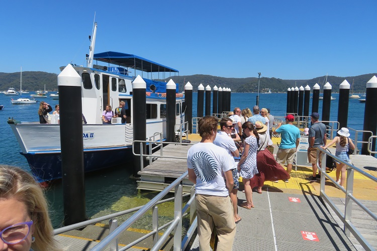 Crowds queue to board the ferry at Palm Beach
