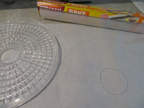 Cutting out the baking paper to fit the dehydrator racks