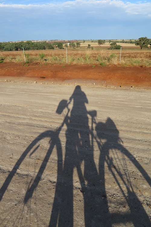 A cyclist shadow on a dirt road east of Dubbo