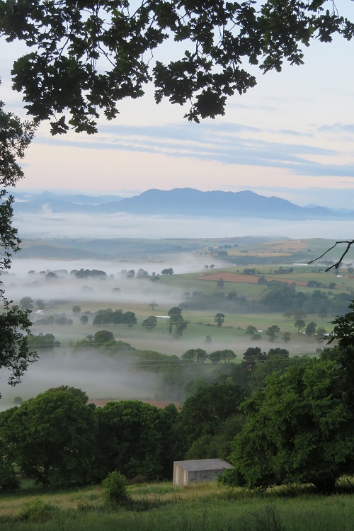 Rolling hills and misty views on the Camino Primitivo, Spain