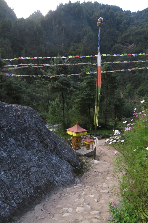 Flags and prayer stones at the edge of the path in the Himalayas