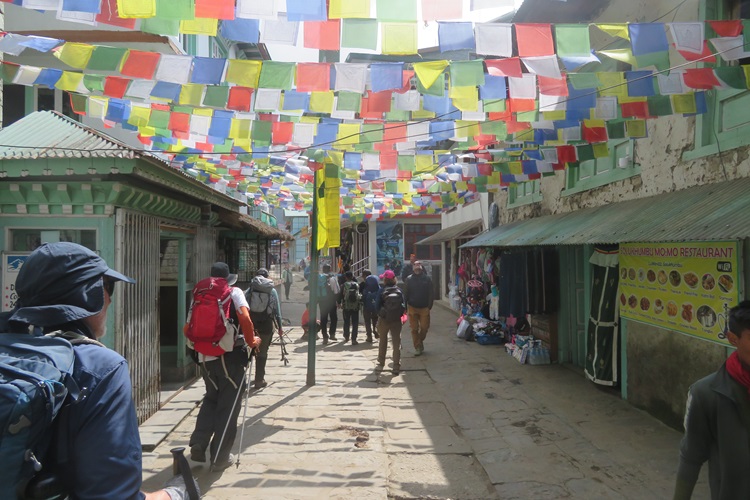 A colourful street draped in flags, Lukla Nepal